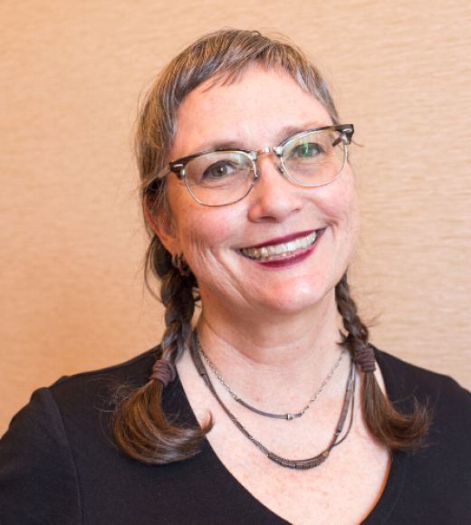 Picture of Kara Moloney wearing a black shirt and hair in braids